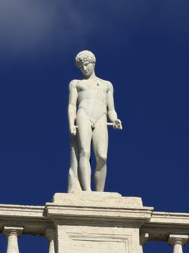A statue atop the Palazzo Nuovo