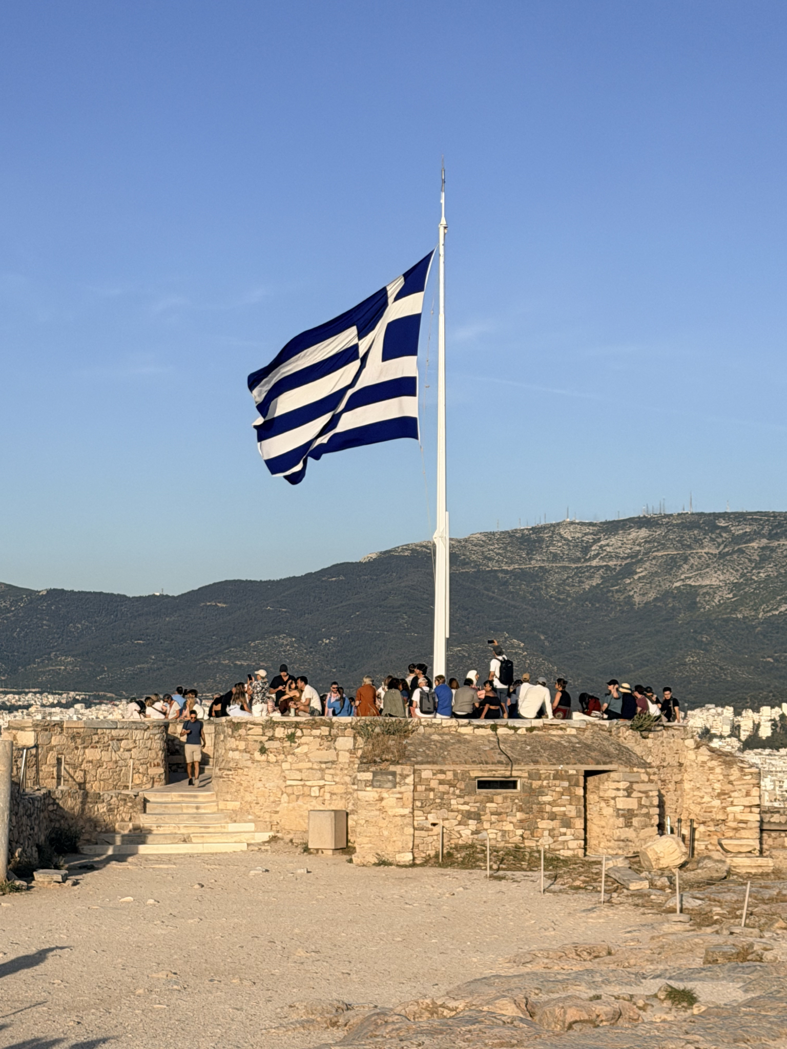 The Greek flag, unfurled and flying proud The Greek flag, unfurled and flying proud